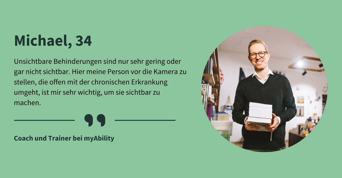 Text: „Michael, 34. Unsichtbare Behinderungen sind nur sehr gering oder gar nicht sichtbar. Hier meine Person vor die Kamera zu stellen, die offen mit der chronischen Erkrankung umgeht, ist mir sehr wichtig, um sie sichtbar zu machen. Coach und Trainer bei myAbility.“ Ein Mann mit kurzen blonden Haaren und Brille steht in einem Geschäft mit Bücherregalen und Postern an den Wänden. Er hält einen Stapel Bücher in den Händen und lächelt in die Kamera.