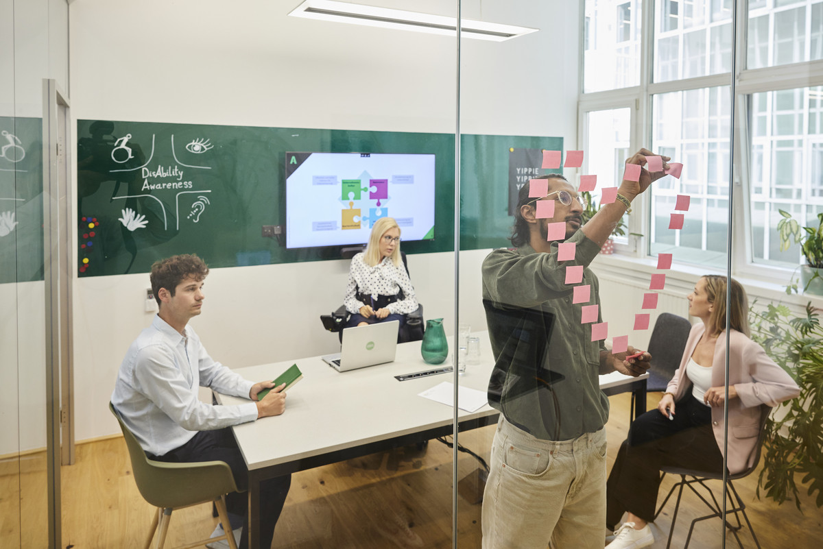 workshop communication. Photo of two female and two male reading people in a meeting situation.